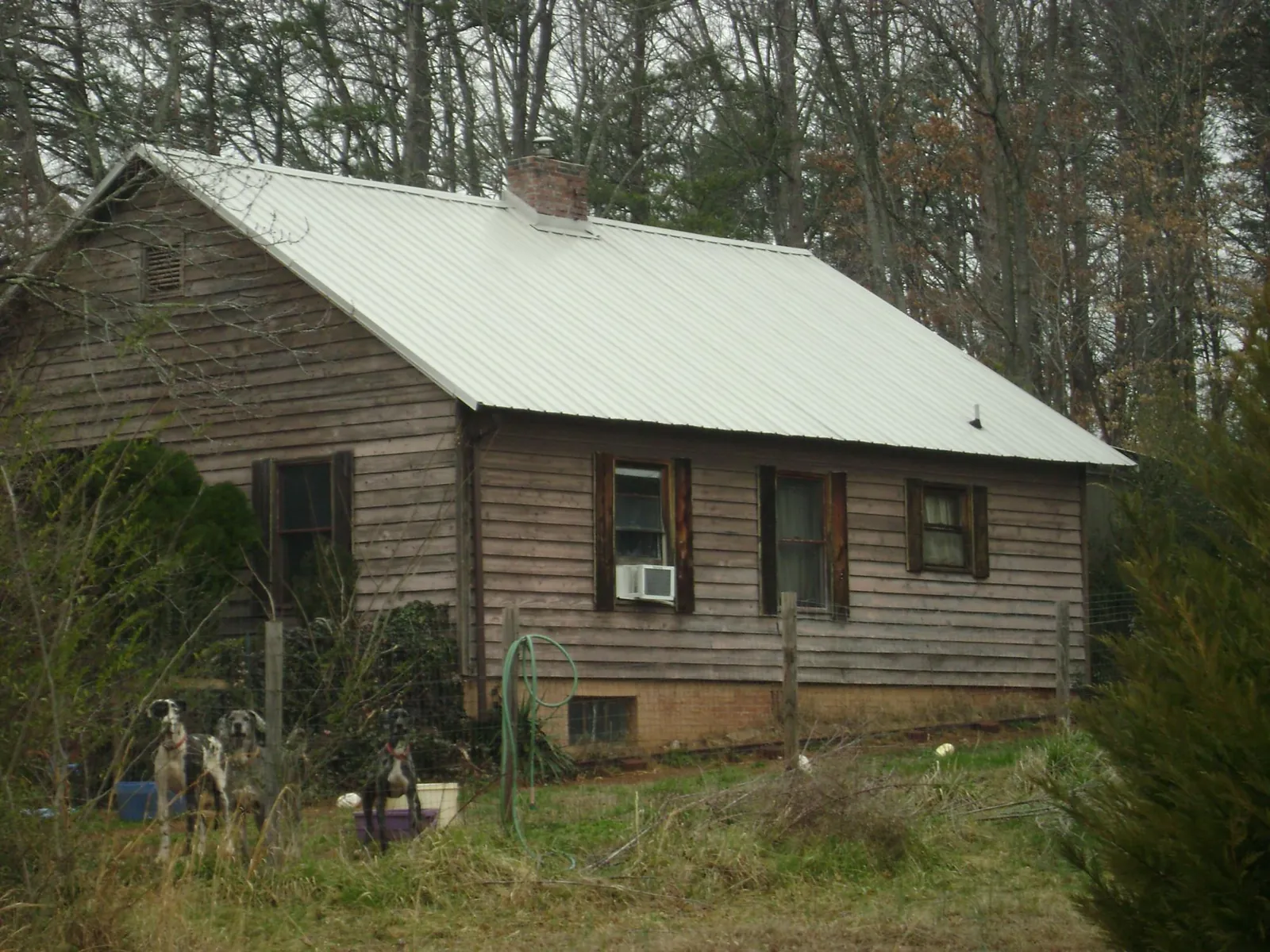White metal roof on an old wood sided farmhouse, from a Metal Roof Installation job in Friendsville